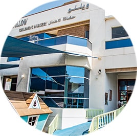 A circular image of a building with a boat on it.