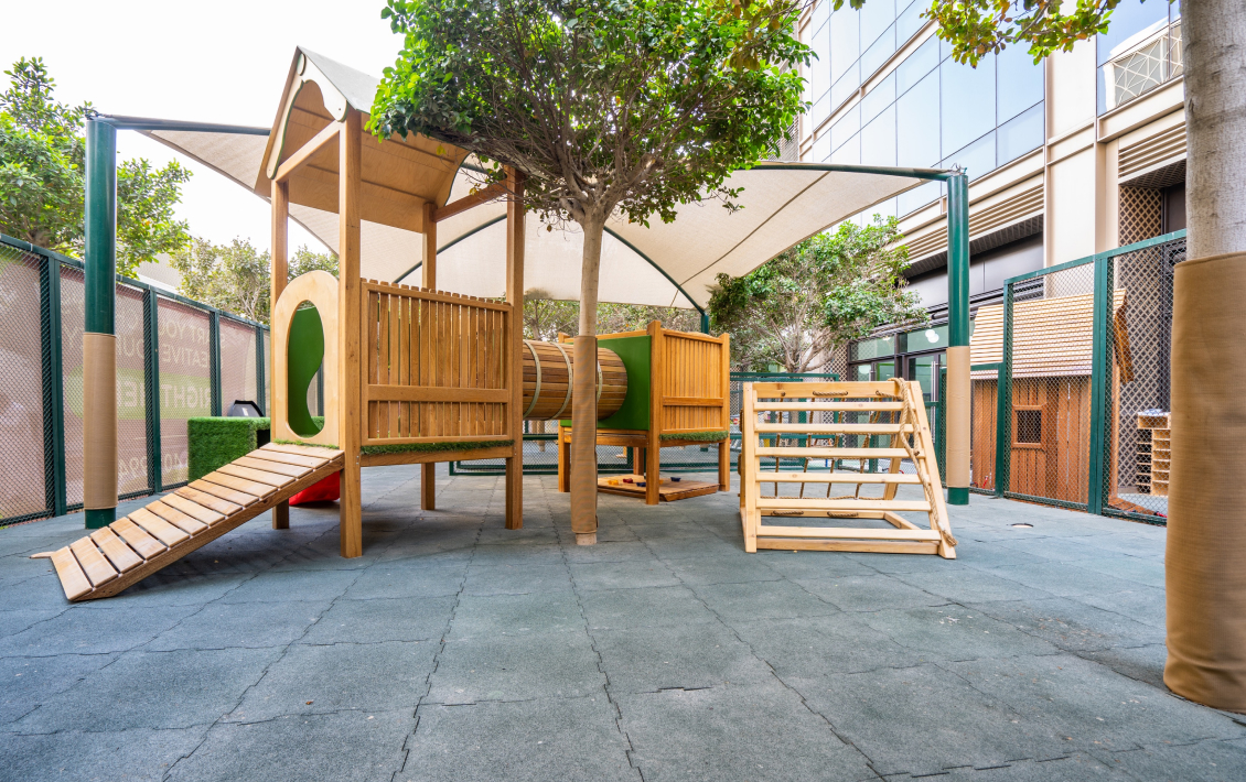 A children's play area with a wooden slide and swings.