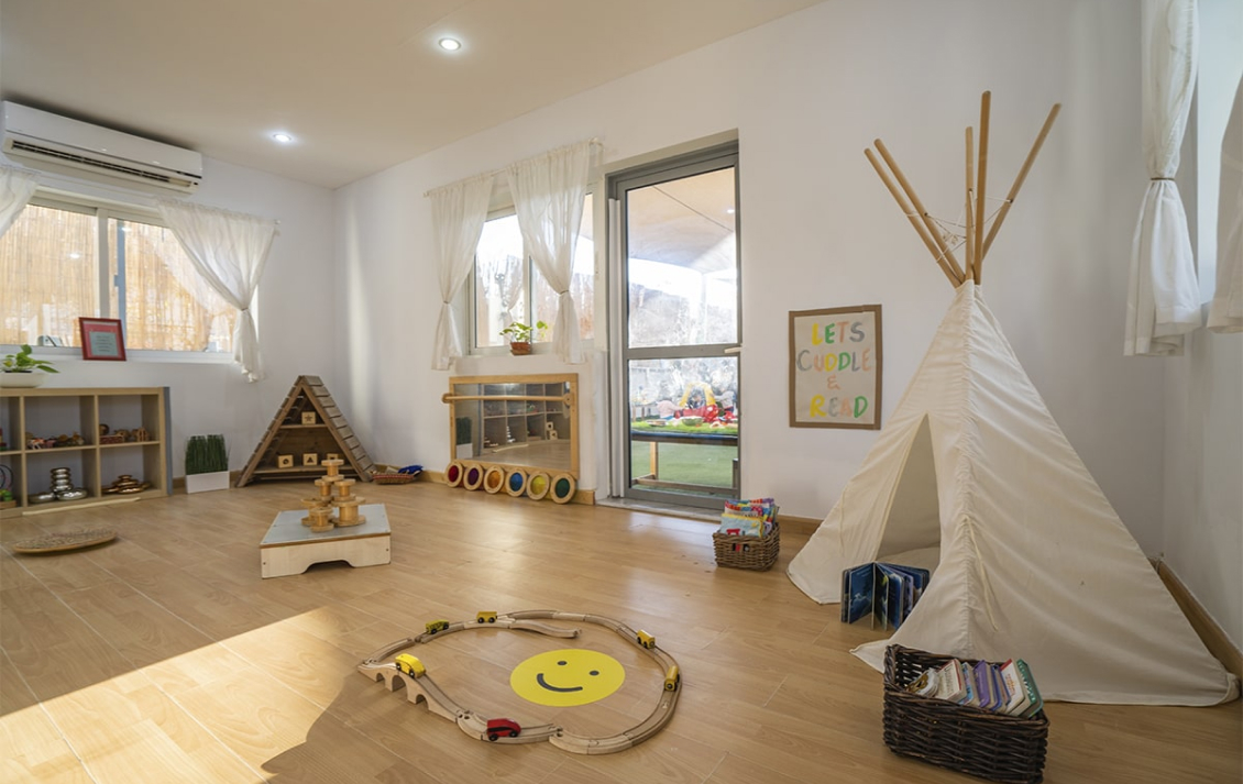 A playroom with toys and a teepee.